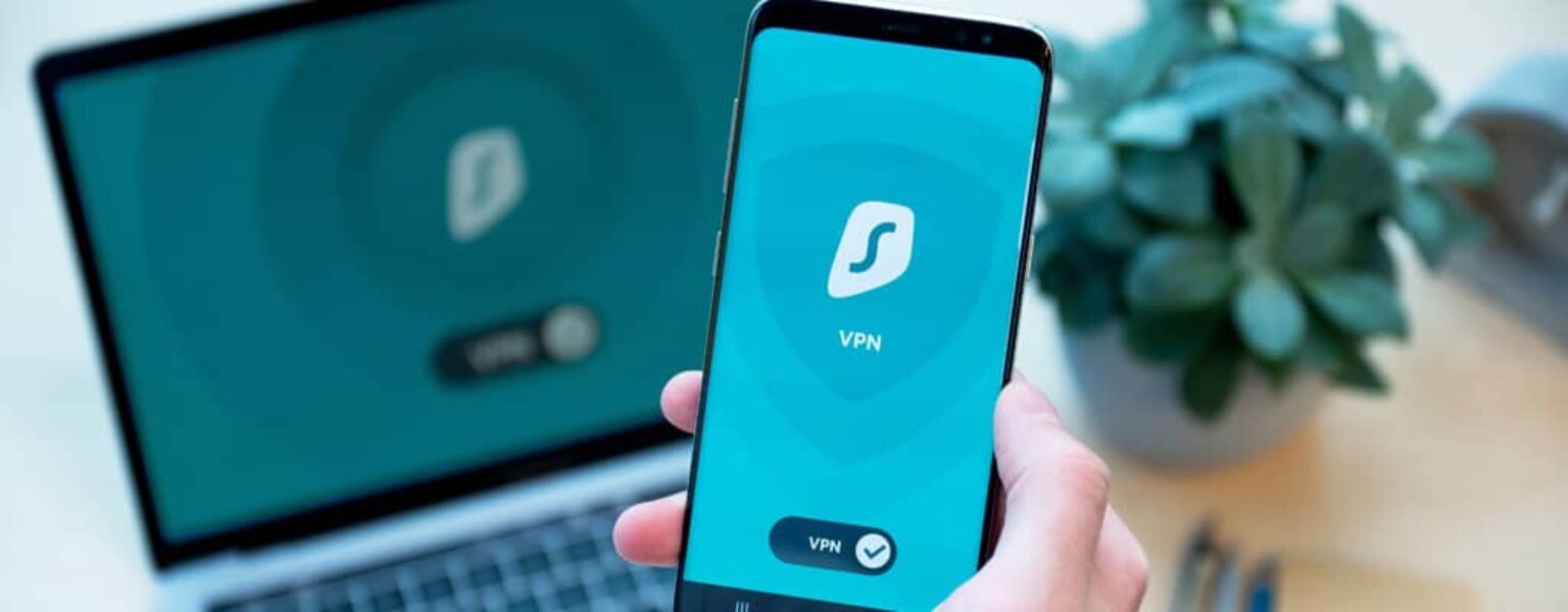 Phone and computer being used to explain how to improve cybersecurity