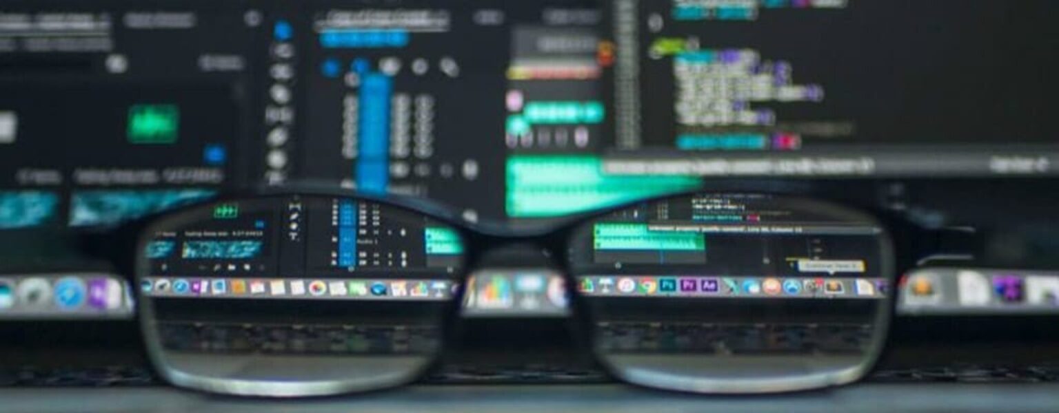 Computer monitor and glasses showing IT infrastructure support professionals