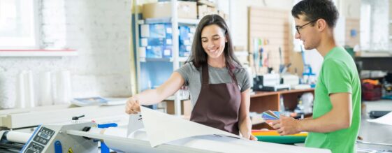 Man helping an art school student with managed print services