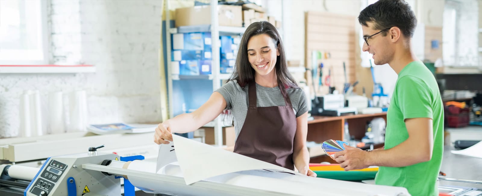 Man helping an art school student with managed print services