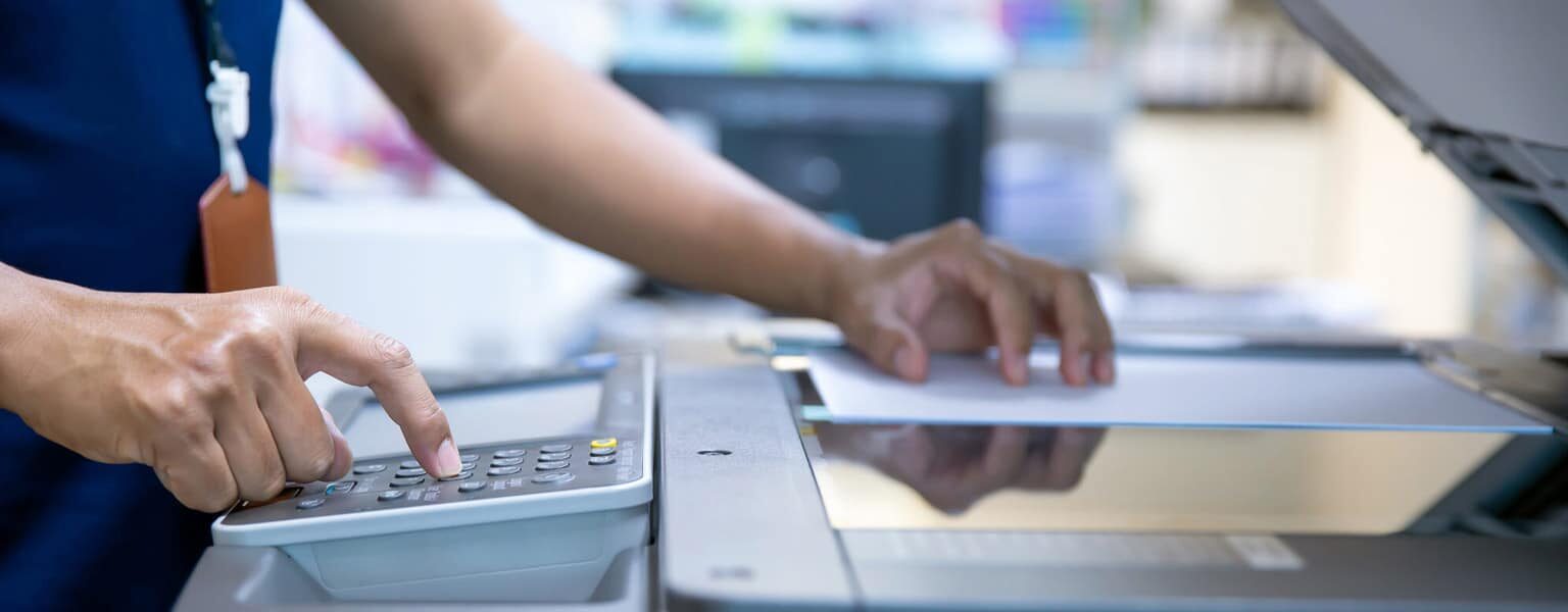 Healthcare worker using a fax machine