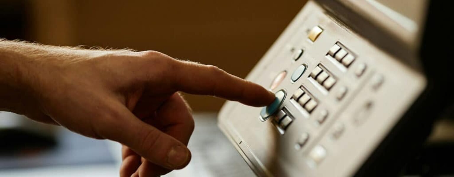 Office worker pressing button on a printer