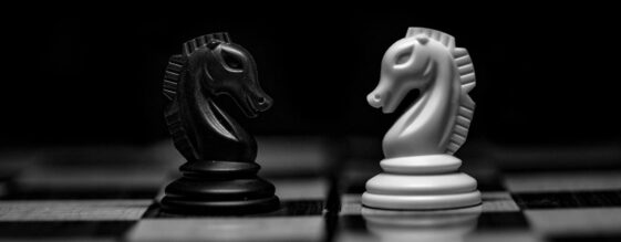 Incident Response VS. Cybersecurity Monitoring Two chess pieces depicting incident response vs cybersecurity monitoring